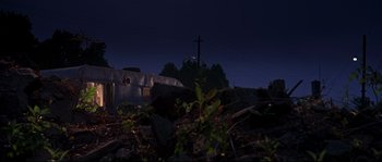 Movie still from “Kalifornia” (1993), directed by Dominic Sena – A view of a house and a power pole at night; Extreme Wide shot, Low angle