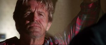 Movie still from “Kalifornia” (1993), directed by Dominic Sena – A man's face in a plaid shirt; Close Up shot, Low angle