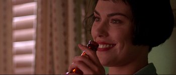 Movie still from “Kalifornia” (1993), directed by Dominic Sena – A person holding a bottle; Close Up shot, Over the shoulder angle