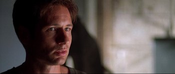 Movie still from “Kalifornia” (1993), directed by Dominic Sena – A man's face in the dark; Close Up shot, Over the shoulder angle
