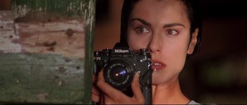 Movie still from “Kalifornia” (1993), directed by Dominic Sena – A woman taking a picture of herself in a mirror; Close Up shot, Low angle