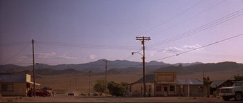 Movie still from “Kalifornia” (1993), directed by Dominic Sena – An empty street in the middle of a desert; Extreme Wide shot, Low angle