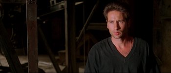 Movie still from “Kalifornia” (1993), directed by Dominic Sena – A person wearing a black shirt; Close Up shot, Low angle