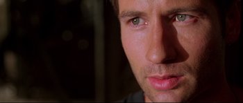 Movie still from “Kalifornia” (1993), directed by Dominic Sena – A man's face with green eyes; Close Up shot, Low angle