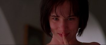 Movie still from “Kalifornia” (1993), directed by Dominic Sena – A person with her finger on her mouth; Close Up shot, Over the shoulder angle