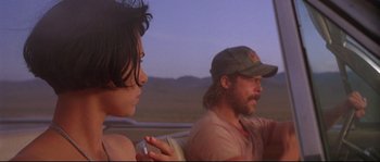 Movie still from “Kalifornia” (1993), directed by Dominic Sena – A man and a woman sitting in a vehicle; Close Up shot, Low angle