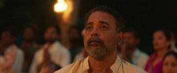 Movie still from “Kantara” (2022), directed by Rishab Shetty – A person with a beard; Close Up shot, Low angle