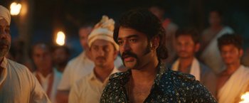 Movie still from “Kantara” (2022), directed by Rishab Shetty – A man with long hair and a mustache; Close Up shot, Over the shoulder angle