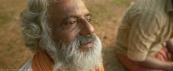 Movie still from “Kantara” (2022), directed by Rishab Shetty – An old man with a long white beard; Close Up shot, Low angle