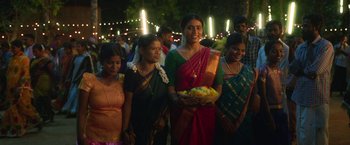 Movie still from “Kantara” (2022), directed by Rishab Shetty – A group of women standing next to each other holding a basket; Medium shot, Low angle