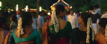 Movie still from “Kantara” (2022), directed by Rishab Shetty – A woman in a green sari with white flowers in her hair; Close Up shot, Over the shoulder angle
