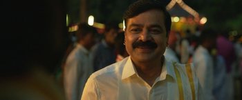 Movie still from “Kantara” (2022), directed by Rishab Shetty – A person wearing a white shirt; Close Up shot, Low angle