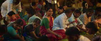 Movie still from “Kantara” (2022), directed by Rishab Shetty – A group of people sitting on the ground; Medium shot, Over the shoulder angle