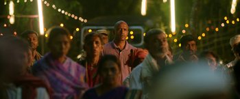Movie still from “Kantara” (2022), directed by Rishab Shetty – A group of people standing in front of a bus at night; Close Up shot, Low angle