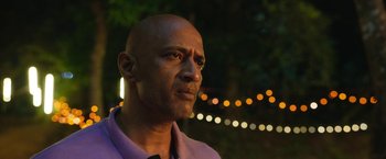 Movie still from “Kantara” (2022), directed by Rishab Shetty – A bald man is looking into the distance; Close Up shot, Over the shoulder angle