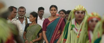 Movie still from “Kantara” (2022), directed by Rishab Shetty – A group of people standing around each other; Medium shot, Low angle