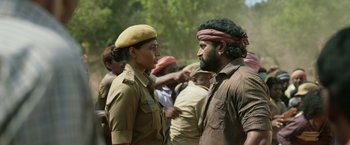 Movie still from “Kantara” (2022), directed by Rishab Shetty – A man and a woman are talking to each other; Medium shot, Over the shoulder angle