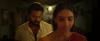 Movie still from “Kantara” (2022), directed by Rishab Shetty – A man and a woman standing next to each other; Close Up shot, Over the shoulder angle