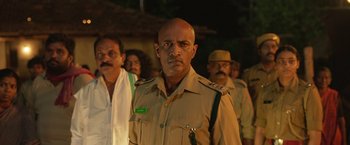 Movie still from “Kantara” (2022), directed by Rishab Shetty – A group of men standing next to each other; Medium shot, Low angle