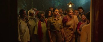 Movie still from “Kantara” (2022), directed by Rishab Shetty – A group of people standing in front of each other; Wide shot, Low angle