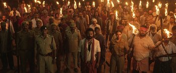 Movie still from “Kantara” (2022), directed by Rishab Shetty – A large group of men are standing in a crowd; Wide shot, High angle