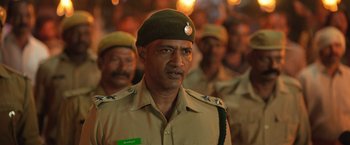 Movie still from “Kantara” (2022), directed by Rishab Shetty – A group of men in uniform standing next to each other; Close Up shot, Low angle