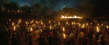 Movie still from “Kantara” (2022), directed by Rishab Shetty – A group of people standing next to each other holding torches; Extreme Wide shot, High angle