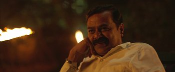 Movie still from “Kantara” (2022), directed by Rishab Shetty – A person with a beard and mustache; Close Up shot, Low angle