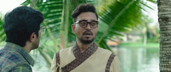 Movie still from “Karwaan” (2018), directed by Akarsh Khurana – A man with glasses is wearing an oriental outfit; Close Up shot, Low angle