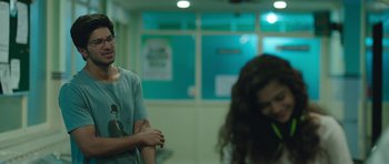 A man and a woman standing next to each other in a room