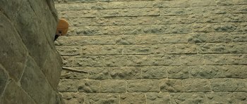 Movie still from “Kesari” (2019), directed by Anurag Singh – A brick wall that has a lot of rocks on it; Extreme Wide shot, Overhead angle