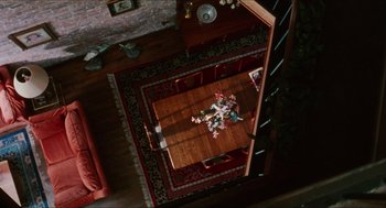 Movie still from “Kids” (1995), directed by Larry Clark – An overhead view of a dining room table and chairs; Extreme Wide shot, Overhead angle