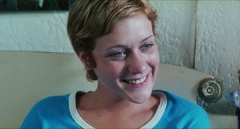 Movie still from “Kids” (1995), directed by Larry Clark – A person with short blonde hair smiling; Close Up shot, High angle
