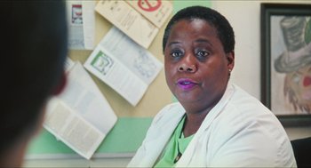 Movie still from “Kids” (1995), directed by Larry Clark – A woman sitting in front of a bulletin board; Close Up shot, Low angle