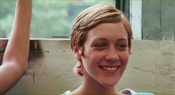 Movie still from “Kids” (1995), directed by Larry Clark – A person smiling; Close Up shot, High angle