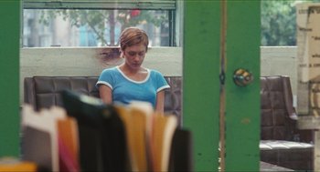 Movie still from “Kids” (1995), directed by Larry Clark – A woman sitting in a booth looking sad; Medium shot, Over the shoulder angle