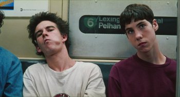 Movie still from “Kids” (1995), directed by Larry Clark – Two young men sitting next to each other on a train; Close Up shot, Low angle