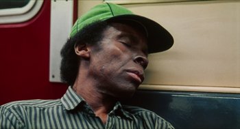 Movie still from “Kids” (1995), directed by Larry Clark – A man in a green hat is sleeping; Close Up shot, High angle