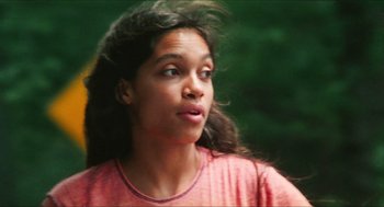Movie still from “Kids” (1995), directed by Larry Clark – A young girl with long dark hair wearing a pink shirt looking to her left; Close Up shot, Low angle