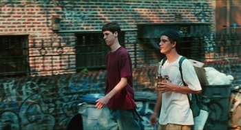 Movie still from “Kids” (1995), directed by Larry Clark – Two young men walking down the street holding drinks; Medium shot, Low angle
