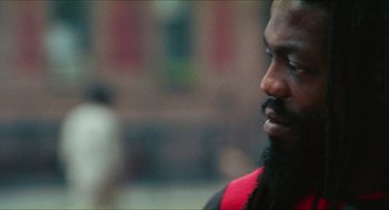 Movie still from “Kids” (1995), directed by Larry Clark – A person with a beard looking down; Close Up shot, Low angle