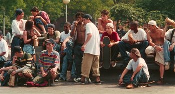 Movie still from “Kids” (1995), directed by Larry Clark – A group of young men sitting on the side of a road; Wide shot, High angle