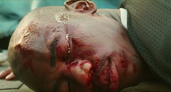 Movie still from “Kids” (1995), directed by Larry Clark – The face of a man with blood all over his face; Extreme Close Up shot, Overhead angle