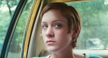 Movie still from “Kids” (1995), directed by Larry Clark – A woman with short blonde hair sitting in the back of a car; Close Up shot, High angle