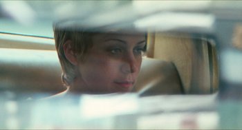 Movie still from “Kids” (1995), directed by Larry Clark – A woman looking out of a car window through a window; Close Up shot, Over the shoulder angle