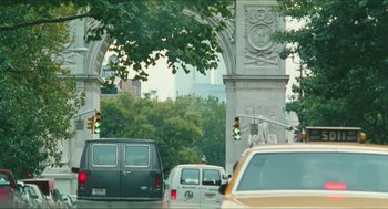 Movie still from “Kids” (1995), directed by Larry Clark – Cars are parked on the side of the road near the arch; Extreme Wide shot, Over the shoulder angle
