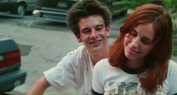 Movie still from “Kids” (1995), directed by Larry Clark – A man and a woman smiling for the camera; Close Up shot, Low angle
