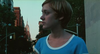 Movie still from “Kids” (1995), directed by Larry Clark – A woman with short blonde hair wearing a blue t - shirt; Close Up shot, Low angle