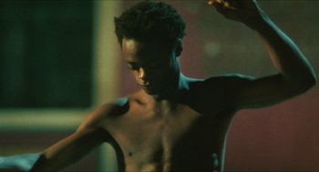 Movie still from “Kids” (1995), directed by Larry Clark – A man with no shirt standing in a room; Close Up shot, Low angle
