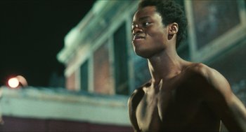 Movie still from “Kids” (1995), directed by Larry Clark – A man with no shirt looking up at the sky; Close Up shot, Low angle